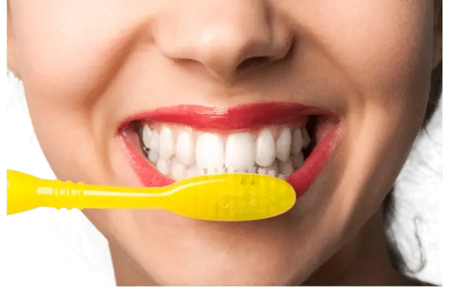 Brushing teeth with fluoride toothpaste